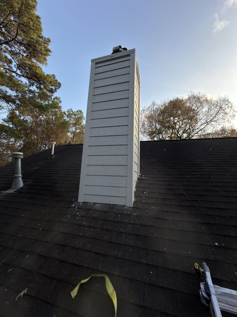 Chimney siding restored after wood rot repair