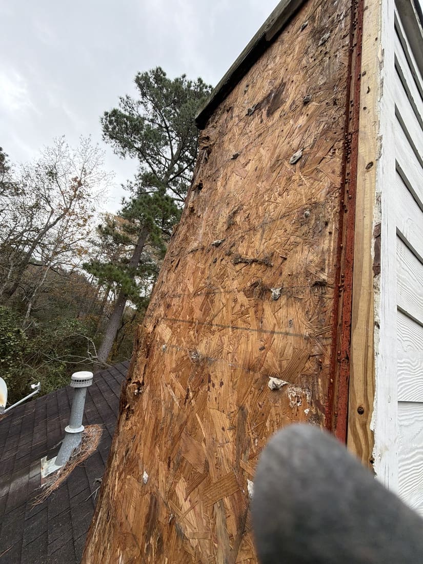 Wood rot damage at siding base