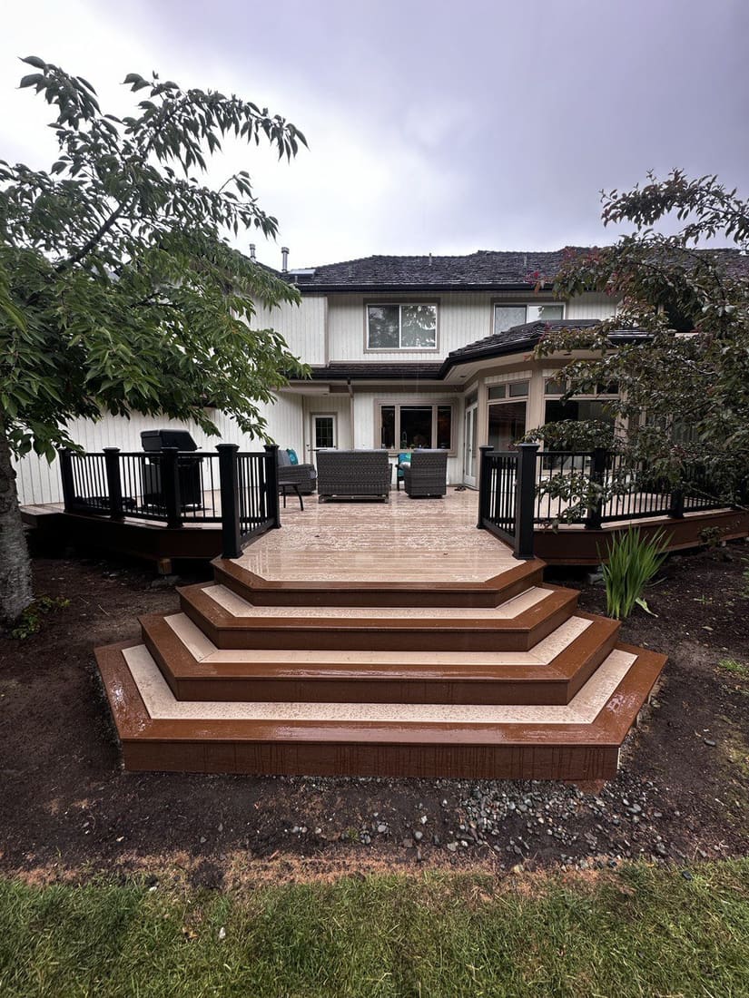 Composite deck with cascading steps — backyard rebuild near The Woodlands